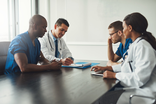 group of diverse medical professionals sitting at a table