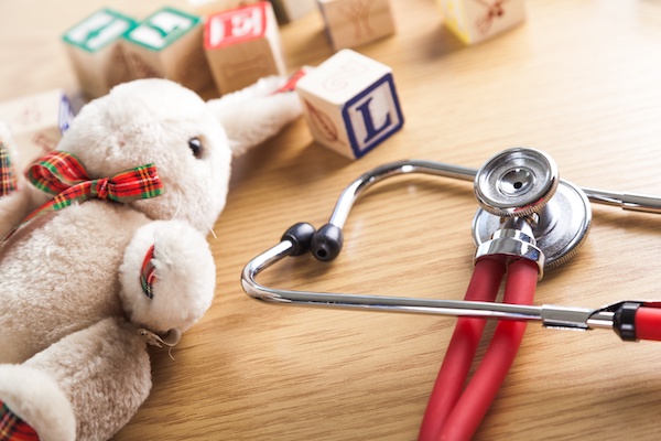 children's toys on tabletop next to stethoscope