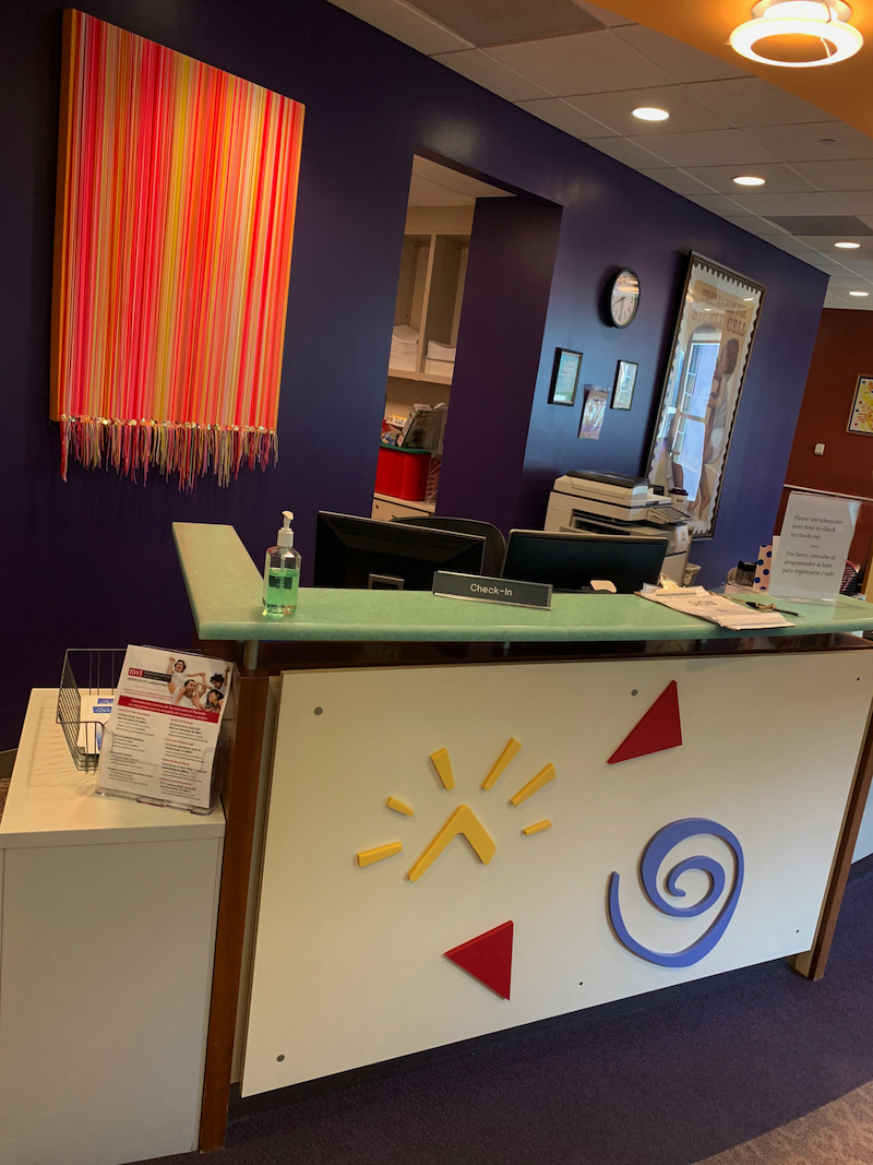 image of the brightly colored pediatric oncology waiting room and check in desk