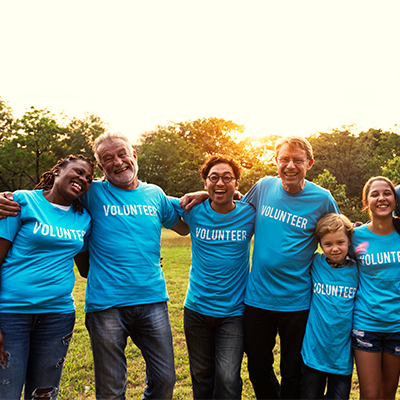 group of people wearing blue shirts that read volunteer