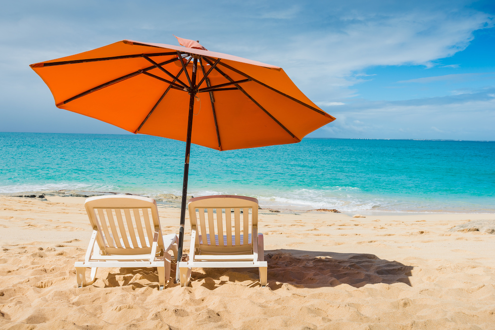 image of two chairs and umbrella on a beach